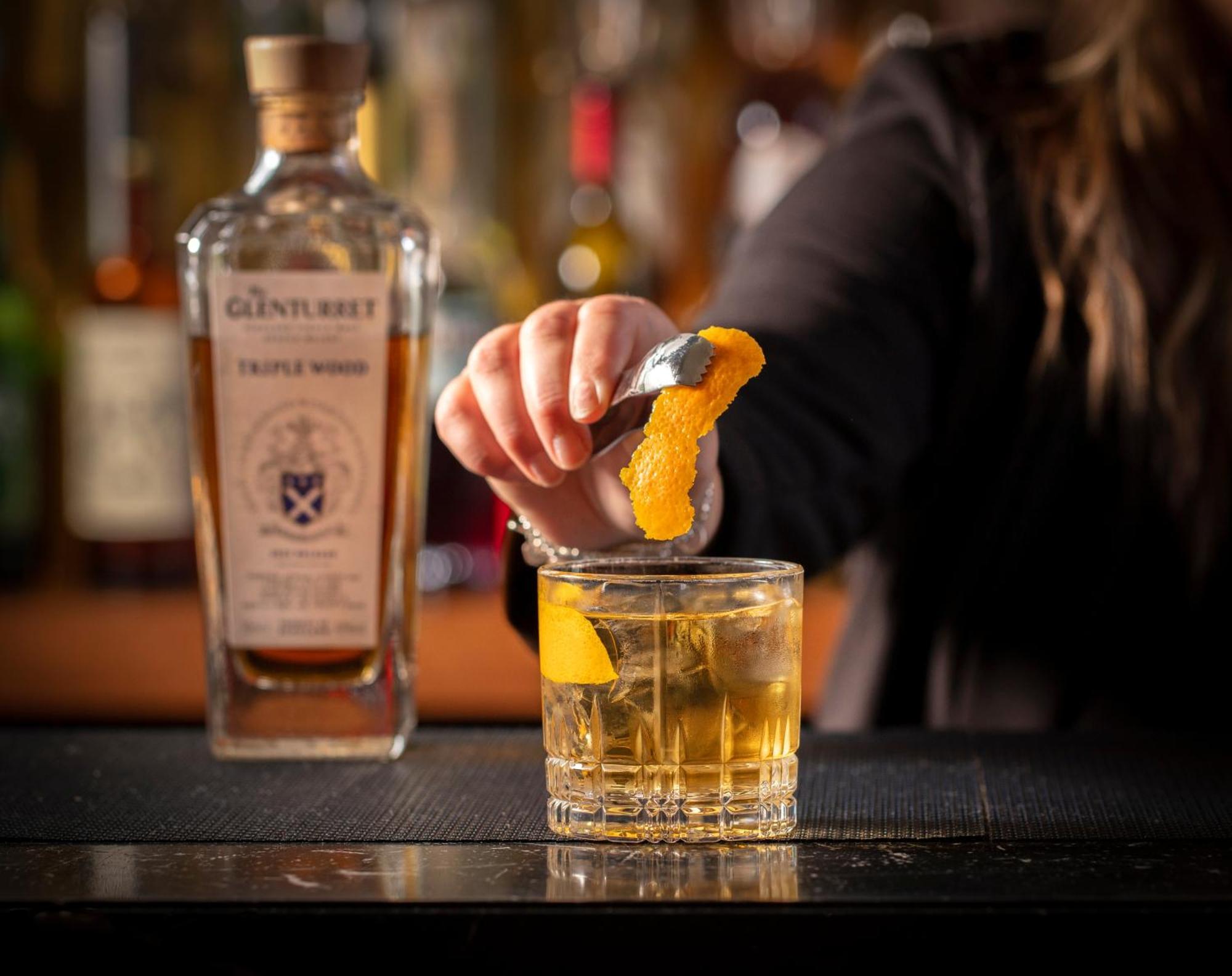 Schloss Roxburghe, Part Of Destination By Hyatt Εξωτερικό φωτογραφία A bartender adding a lemon twist to a glass of GINfinity